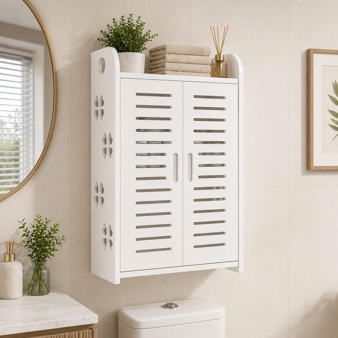 White wooden wall cabinet with slatted doors mounted on a tiled wall above a toilet.