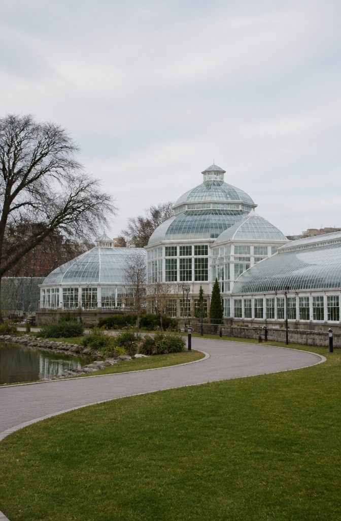 Multiple conservatories at Brooklyn Botanic Garden each housing different plant types.