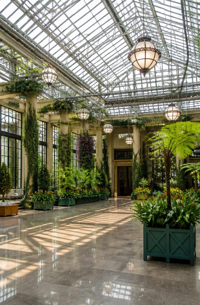 Expansive indoor gardens at Longwood Gardens filled with diverse plant life.