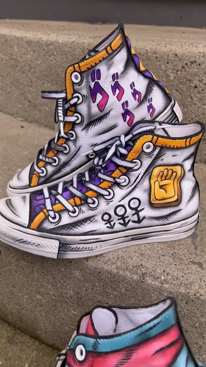 Custom hand-drawn anime style high-top canvas sneakers resting on a concrete step.