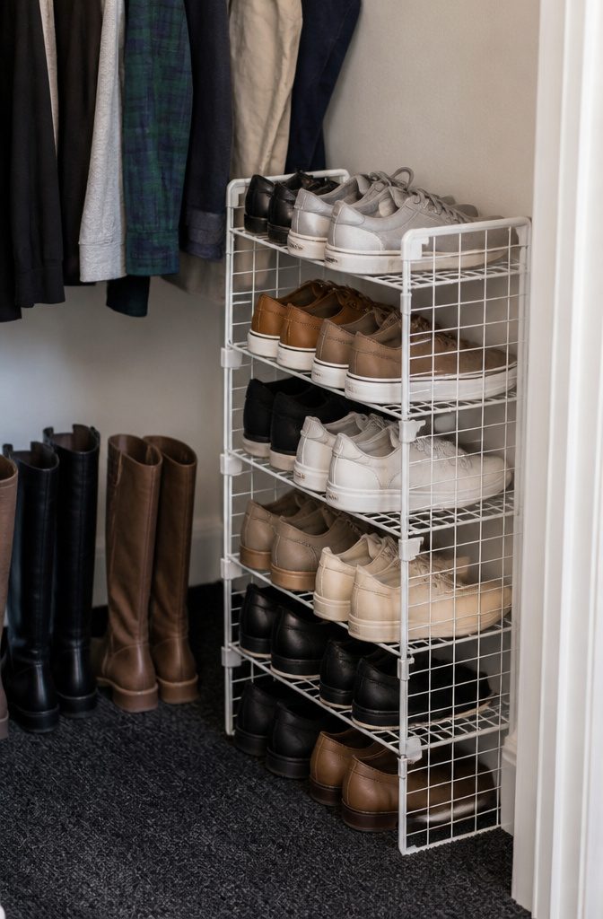 20 Dollar Tree Home Hacks for Organizing Every Room 12 Wire shelves arranged as a shoe rack holding sneakers in a closet.