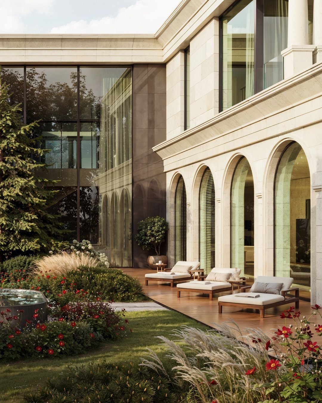 13 Estate Garden Design Ideas With Photos and Planning Tips 13 A luxury estate courtyard with arched windows, wooden lounge chairs, and lush garden landscaping.