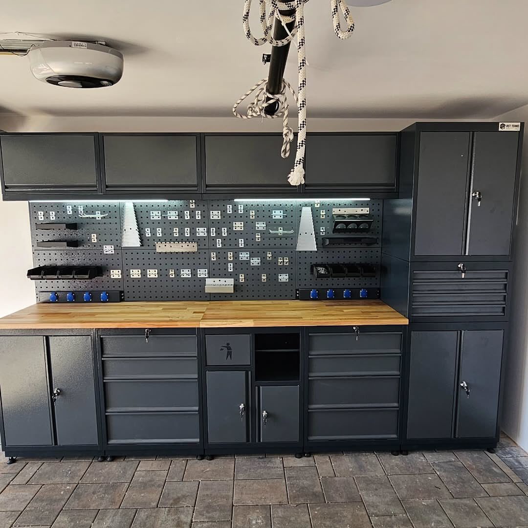 Dark grey garage storage system with a wooden workbench, pegboard, and various tool cabinets.