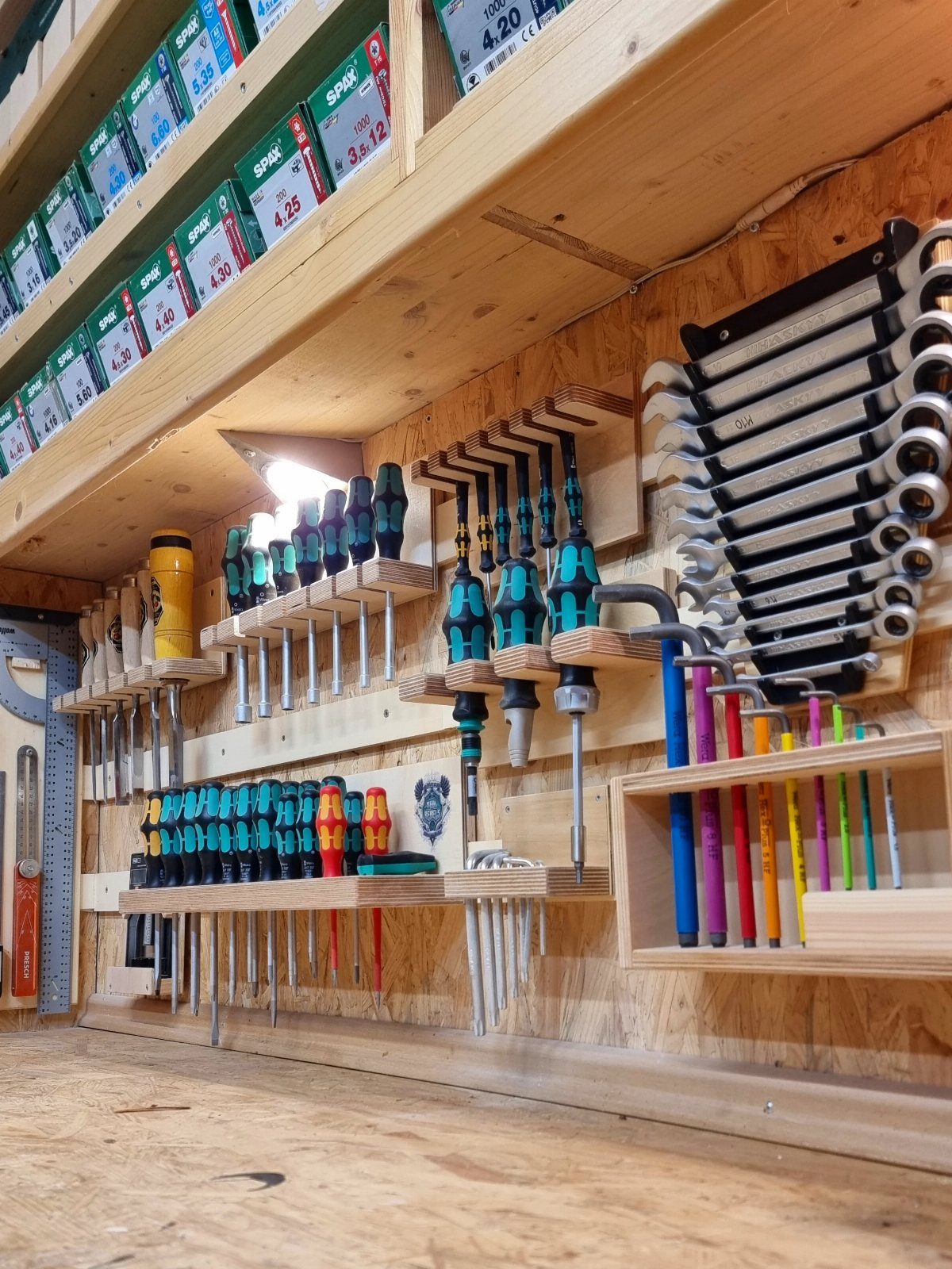 Garage Storage and Workshop: 8 Ideas That Actually Fit 8 Organized hand tools including screwdrivers and wrenches mounted on wooden shelves in a workshop.