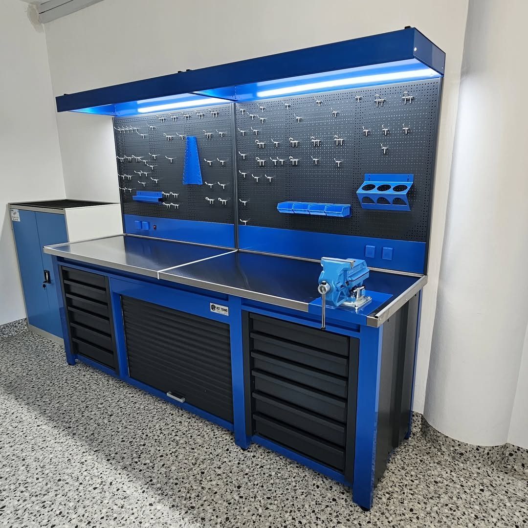 Garage Storage and Workshop: 8 Ideas That Actually Fit 1 Blue and black modular workshop storage system with a metal workbench and tool pegboards.