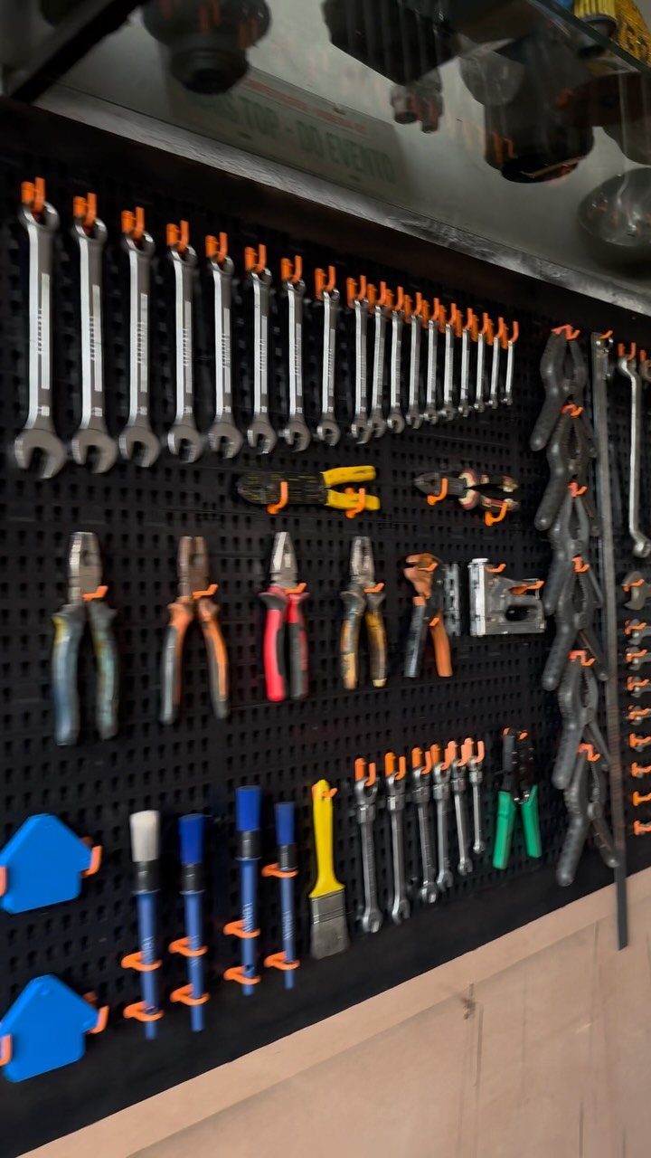 Garage Storage and Workshop: 8 Ideas That Actually Fit 7 Various hand tools organized on a black pegboard with orange tool holders.