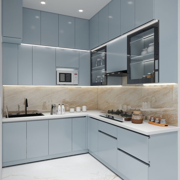 Modern minimalist kitchen with light blue glossy cabinets and marble backsplash under warm lighting.
