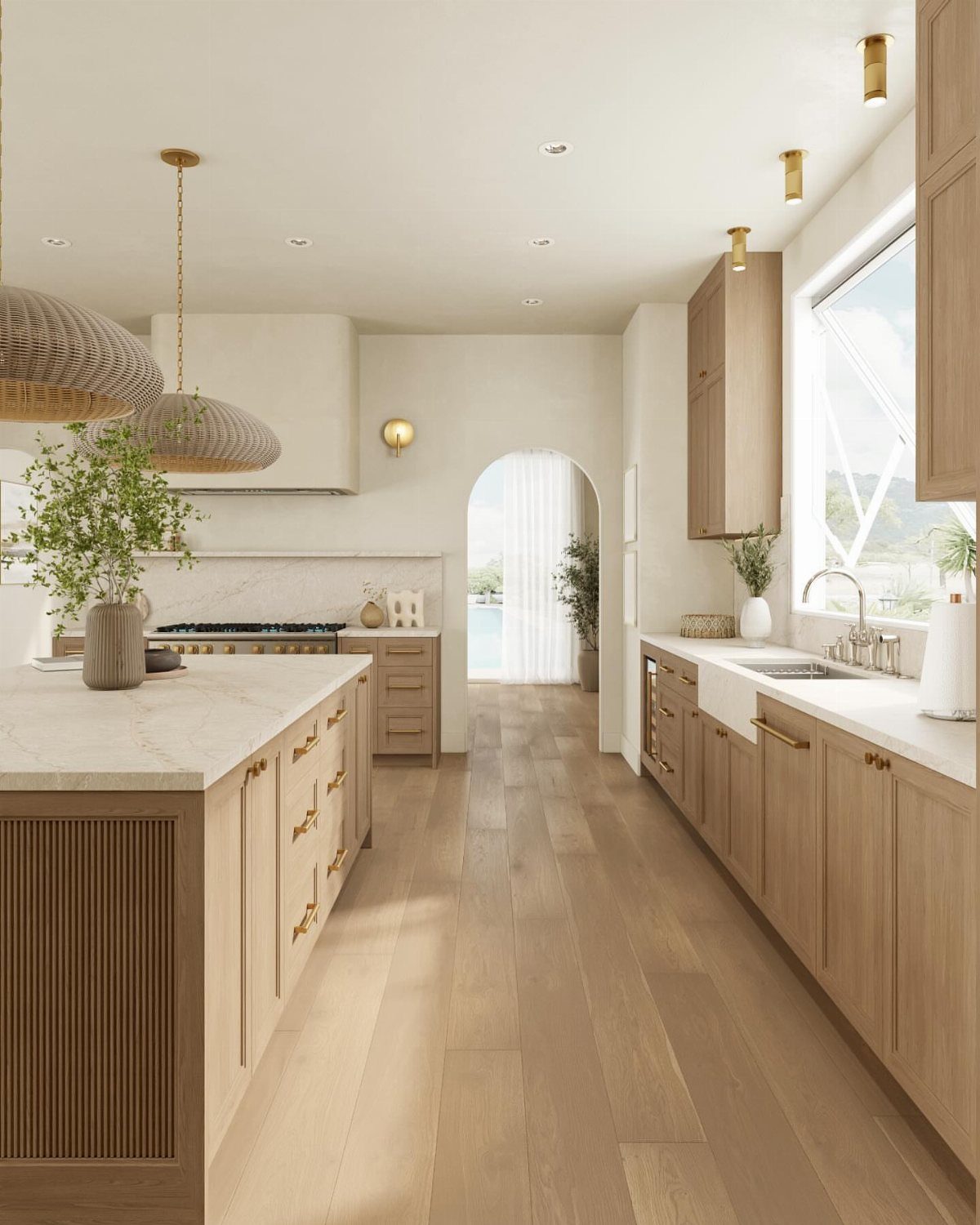 A bright modern kitchen with light wood cabinets, marble countertops, and woven pendant lights.