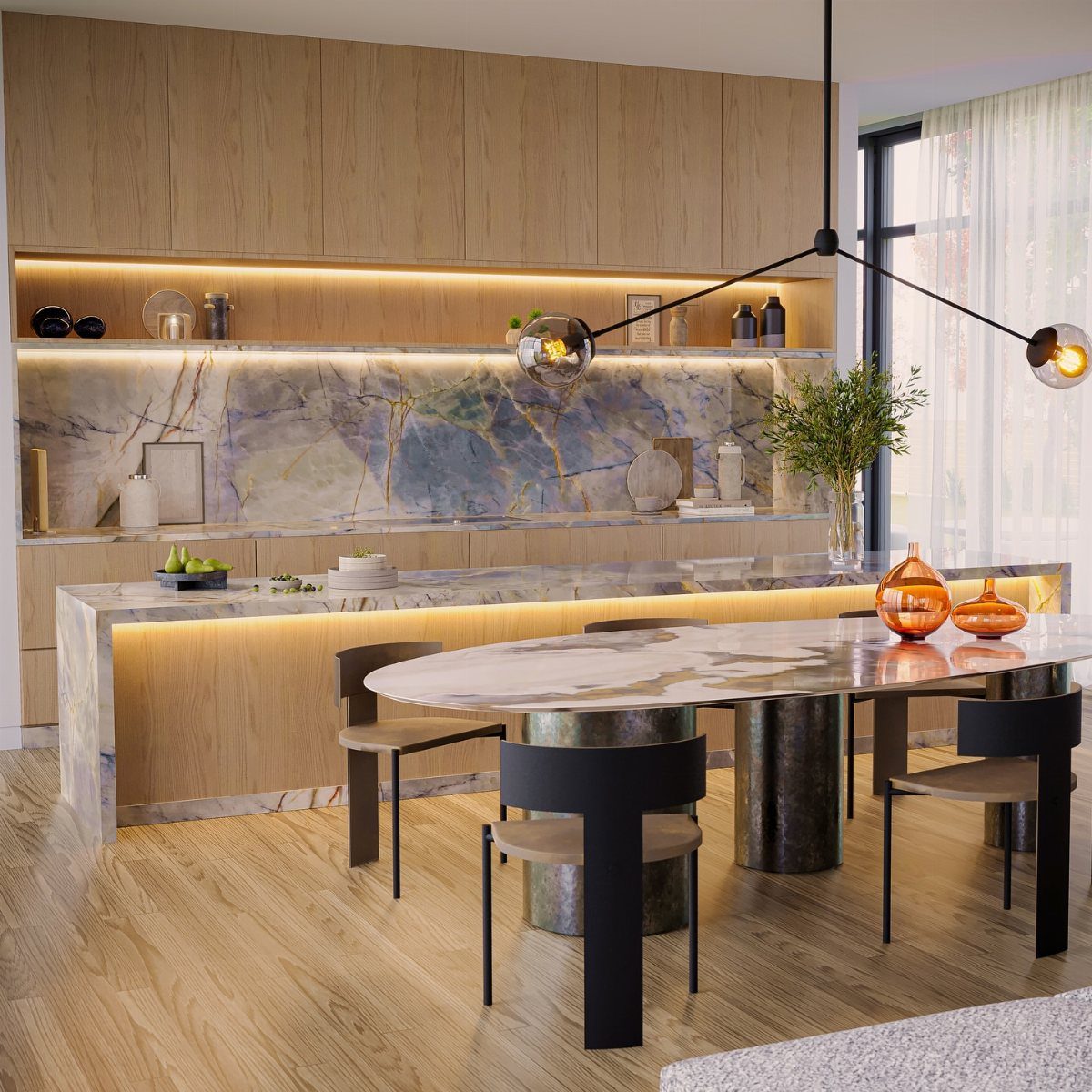 Marble countertops and island with integrated lighting in a modern kitchen and dining room.