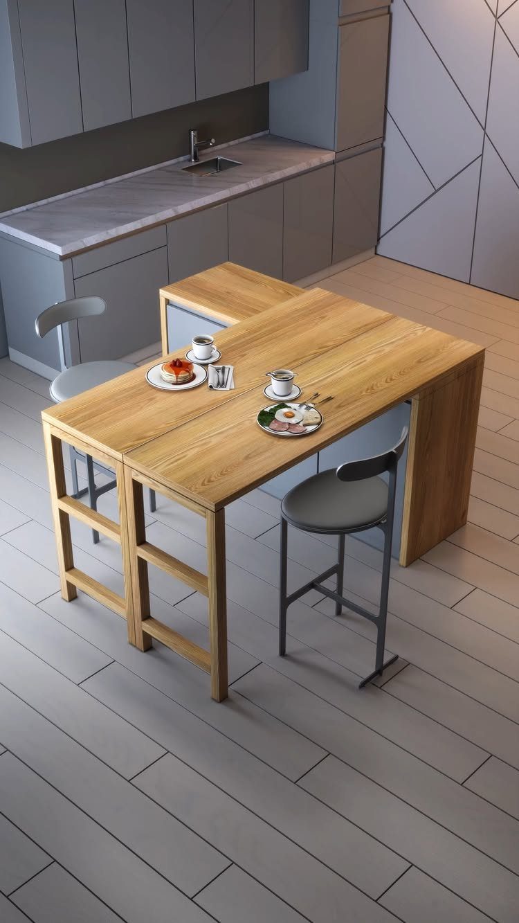 Light wood dining table with grey chairs and a bench in a modern kitchen.