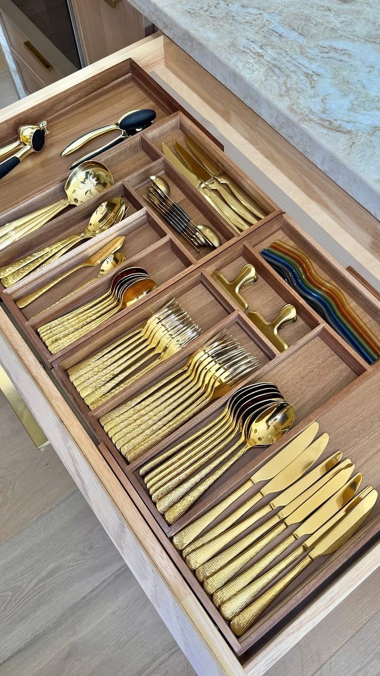13 Kitchen Organization Ideas for Small Spaces That Free Up Real Room 3 Gold metal utensils organized in a wooden kitchen drawer using dividers.