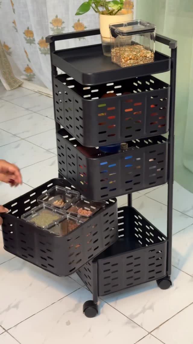 13 Kitchen Organization Ideas for Small Spaces That Free Up Real Room 1 A black three-tier rolling storage cart with plastic bins being used to organize items.