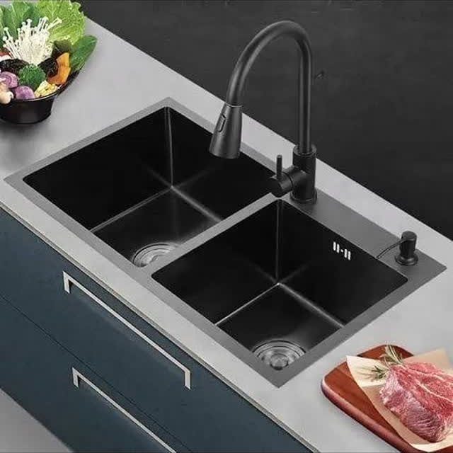 12 Latest Kitchen Sink Design Ideas for 2026 4 Matte black double-bowl kitchen sink with a matching black faucet installed in a grey countertop.