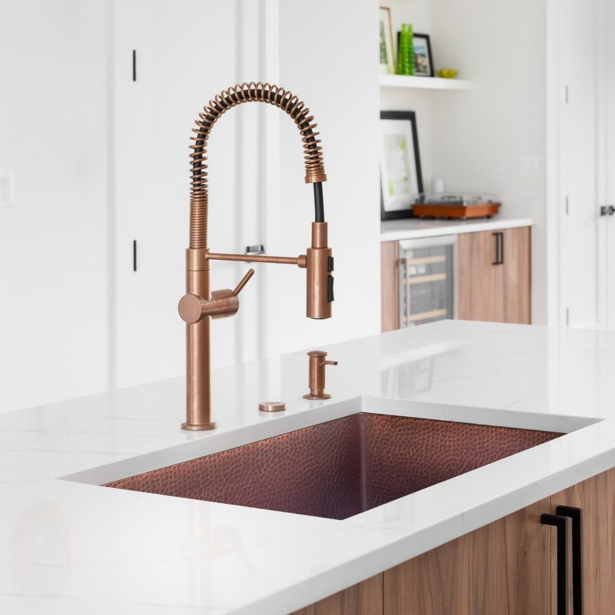 12 Latest Kitchen Sink Design Ideas for 2026 10 A hammered copper undermount sink and matching copper faucet on a white marble countertop.