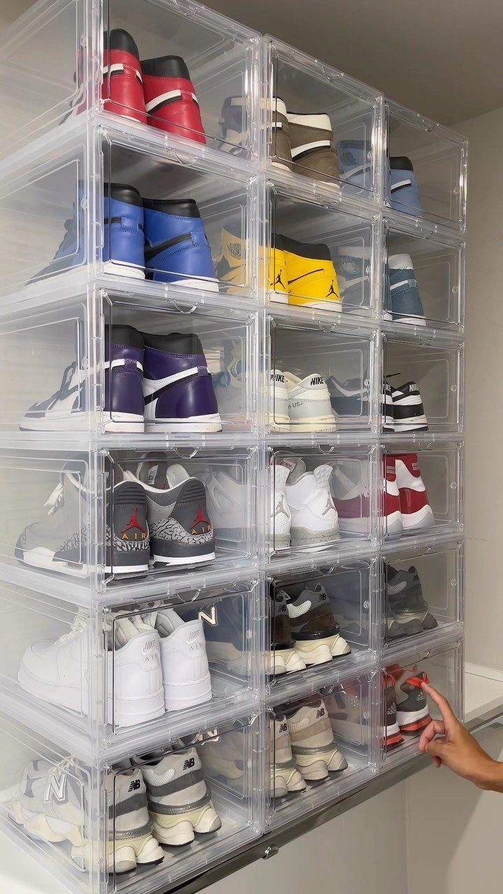 11 Ideas to Organize a Closet for Maximum Storage 3 Clear acrylic shoe boxes stacked high, filled with various colorful sneakers in a closet setting.