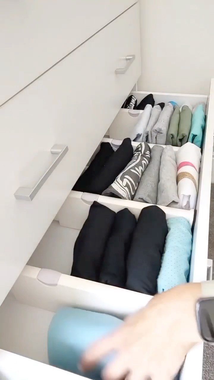 11 Ideas to Organize a Closet for Maximum Storage 6 White dresser drawers containing neatly folded clothes separated by white plastic dividers.