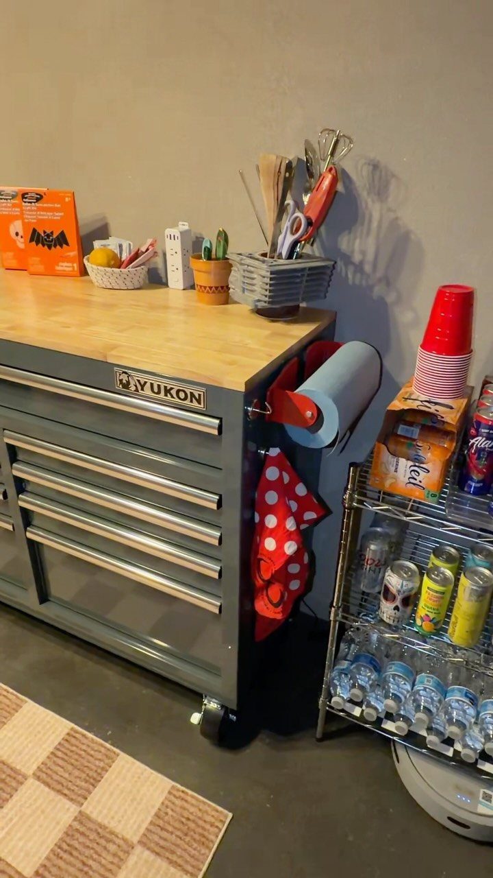 22 Organize a Garage Ideas for Workbenches, Zones & Wall Systems 1 A wooden topped metal tool chest used as a workbench in a garage setting.
