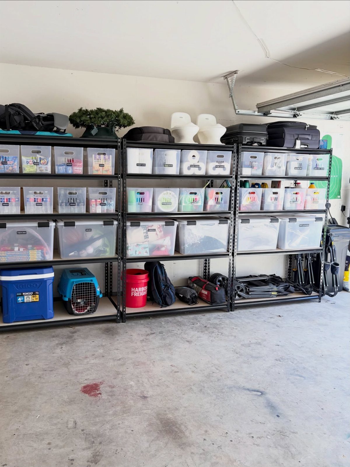 22 Organize a Garage Ideas for Workbenches, Zones & Wall Systems 8 Black metal shelves filled with clear plastic storage bins in an organized garage setting.