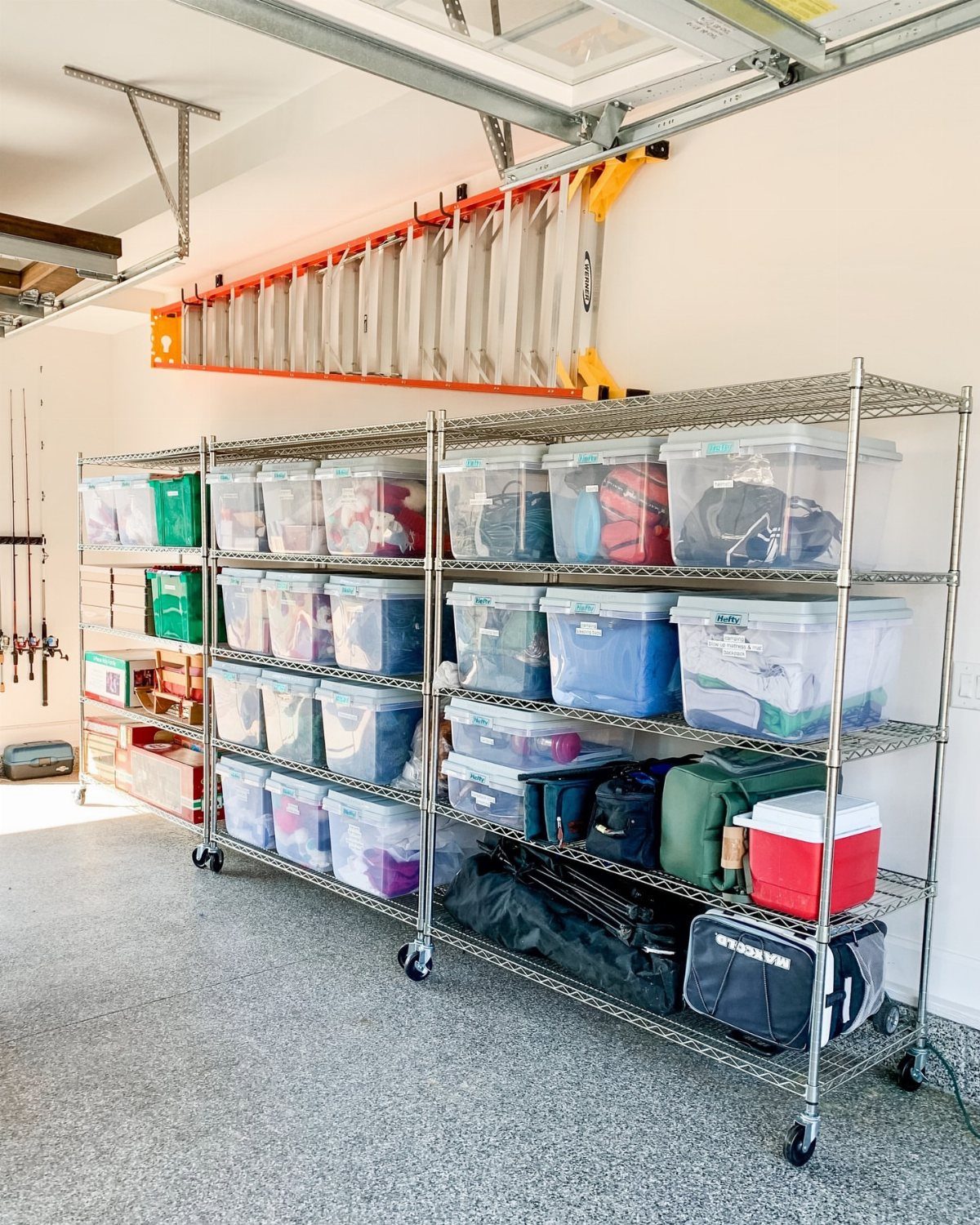 22 Organize a Garage Ideas for Workbenches, Zones & Wall Systems 19 Orange ladder mounted horizontally on a garage wall above large metal wire storage shelving units.