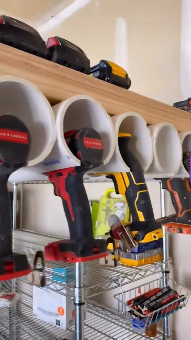 22 Organize a Garage Ideas for Workbenches, Zones & Wall Systems 4 Cordless power drills stored inside white PVC pipe holders mounted to a wooden shelf.