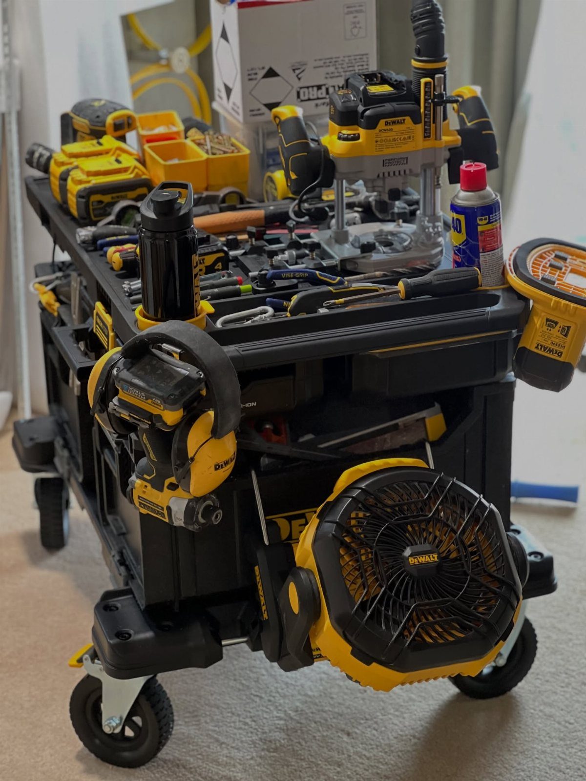 22 Organize a Garage Ideas for Workbenches, Zones & Wall Systems 18 A black and yellow rolling tool cart filled with various power tools and equipment.