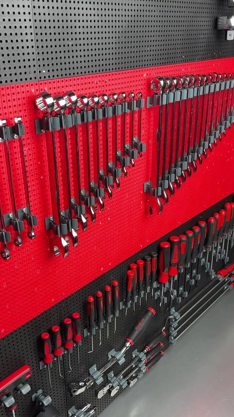 22 Organize a Garage Ideas for Workbenches, Zones & Wall Systems 21 Various metal hand tools hanging organized on a red and black pegboard wall system.