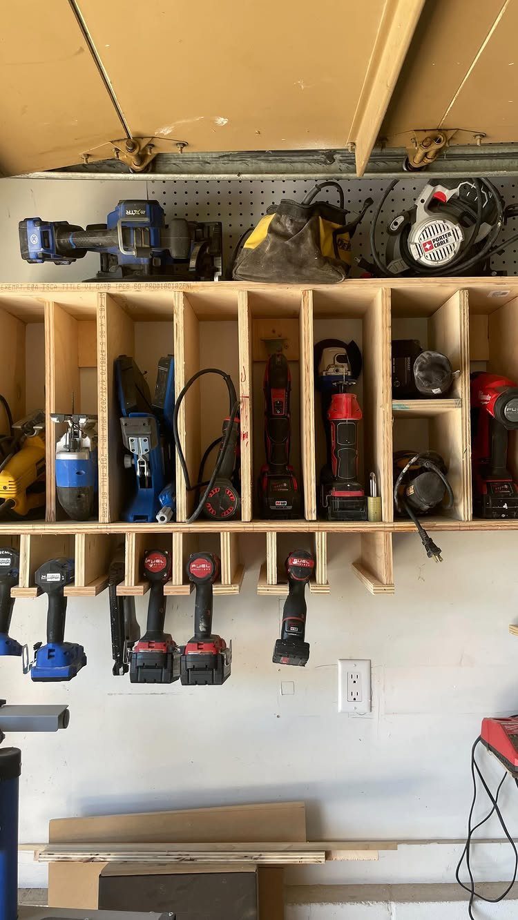 22 Organize a Garage Ideas for Workbenches, Zones & Wall Systems 5 Wooden tool storage shelves holding various power tools and cordless drills against a white wall.