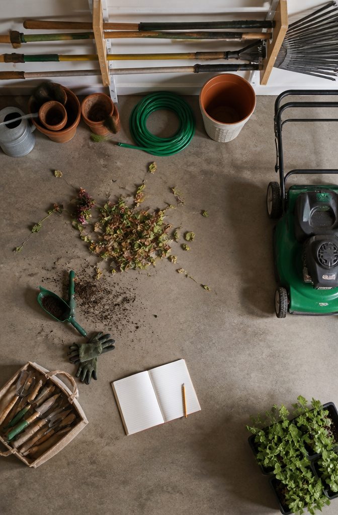 A written inventory of gardening tools displayed in a garage.