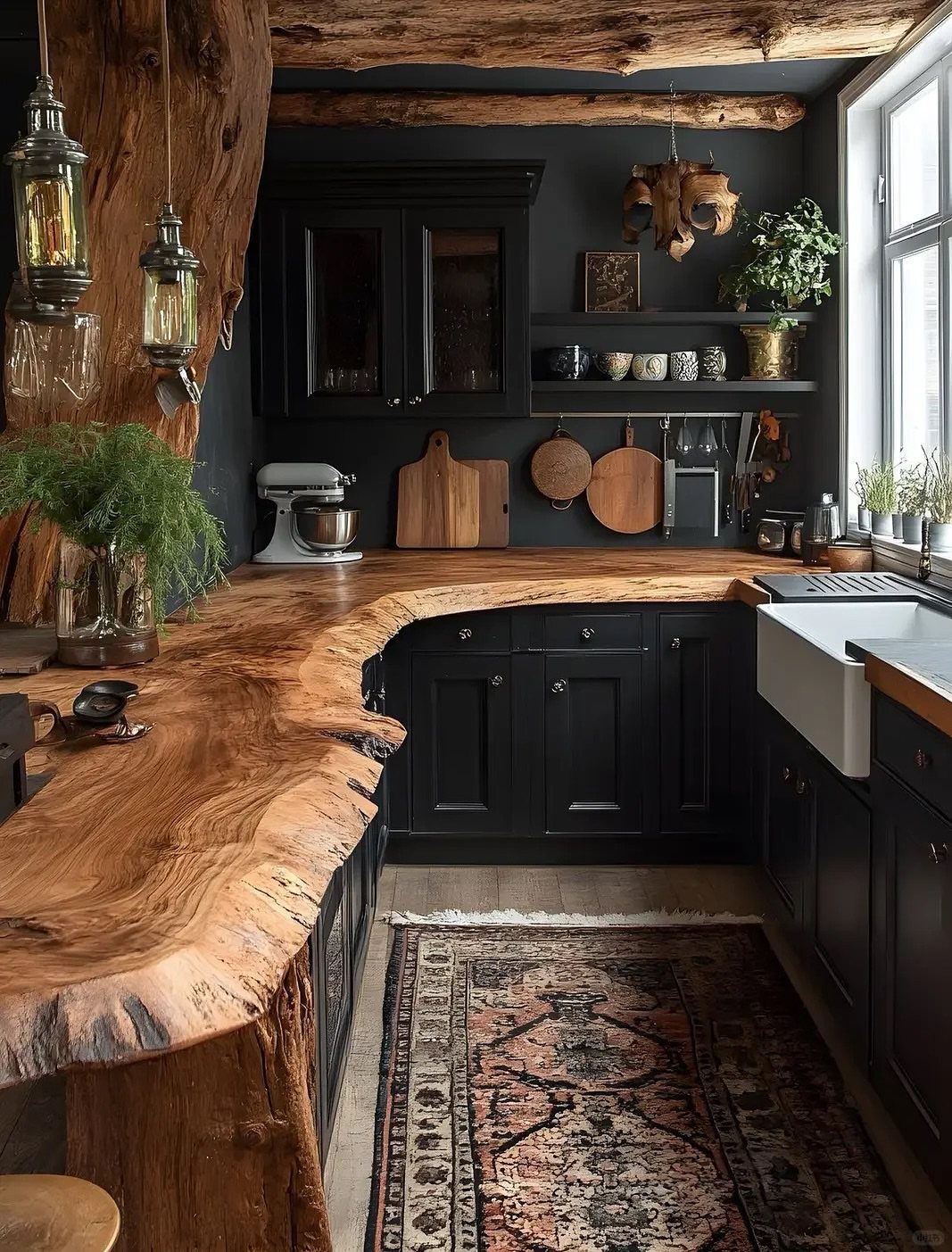 Rustic kitchen with live-edge wood countertops, black cabinets, and a white farmhouse sink.