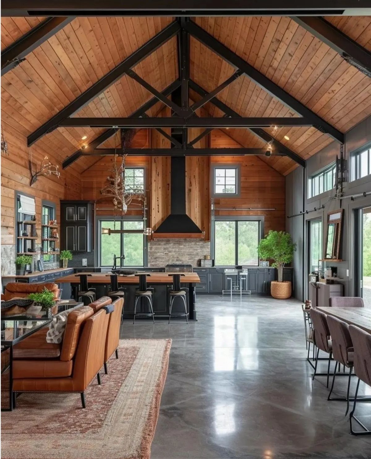 Rustic kitchen with vaulted wood ceilings, black metal trusses, and a large central island.