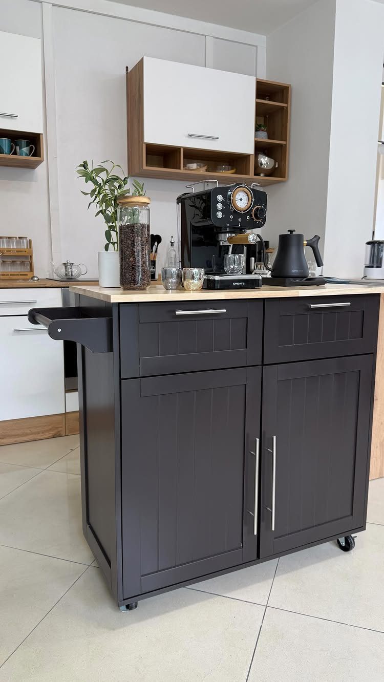 A dark grey mobile kitchen cart with a wooden top holding an espresso machine and coffee accessories.