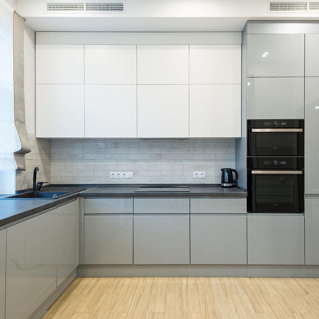 20 Simple and Small Kitchen Design Ideas 15 Glossy grey and white kitchen cabinets with a dark countertop and tiled backsplash.