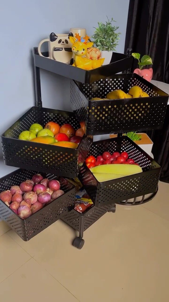 20 Simple and Small Kitchen Design Ideas 19 A black metal rolling cart with perforated baskets filled with various colorful fruits.