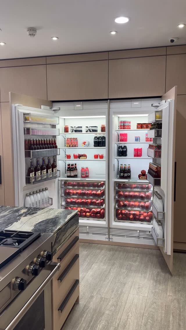20 Sleek Kitchen Cabinet Design Ideas for 2026 18 Open built-in refrigerators stocked with food and drinks inside sleek beige kitchen cabinetry.