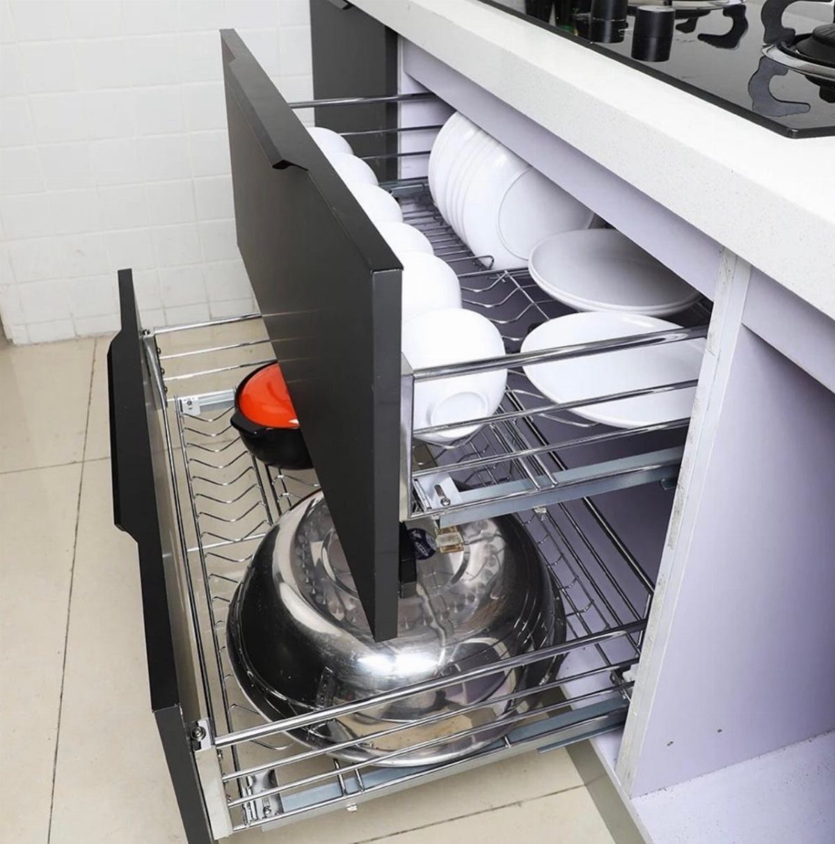 20 Sleek Kitchen Cabinet Design Ideas for 2026 5 Open kitchen cabinet drawers containing white ceramic dishes and a large stainless steel cooking pot.