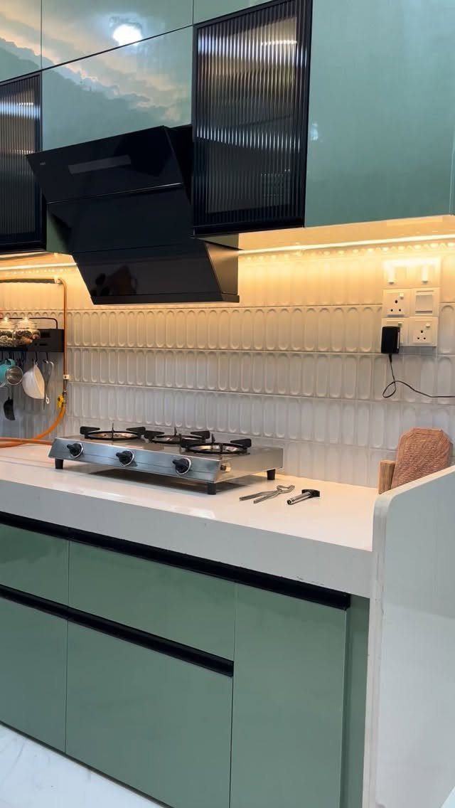 20 Sleek Kitchen Cabinet Design Ideas for 2026 10 Sage green high-gloss kitchen cabinets with a white countertop and stainless steel gas stove.