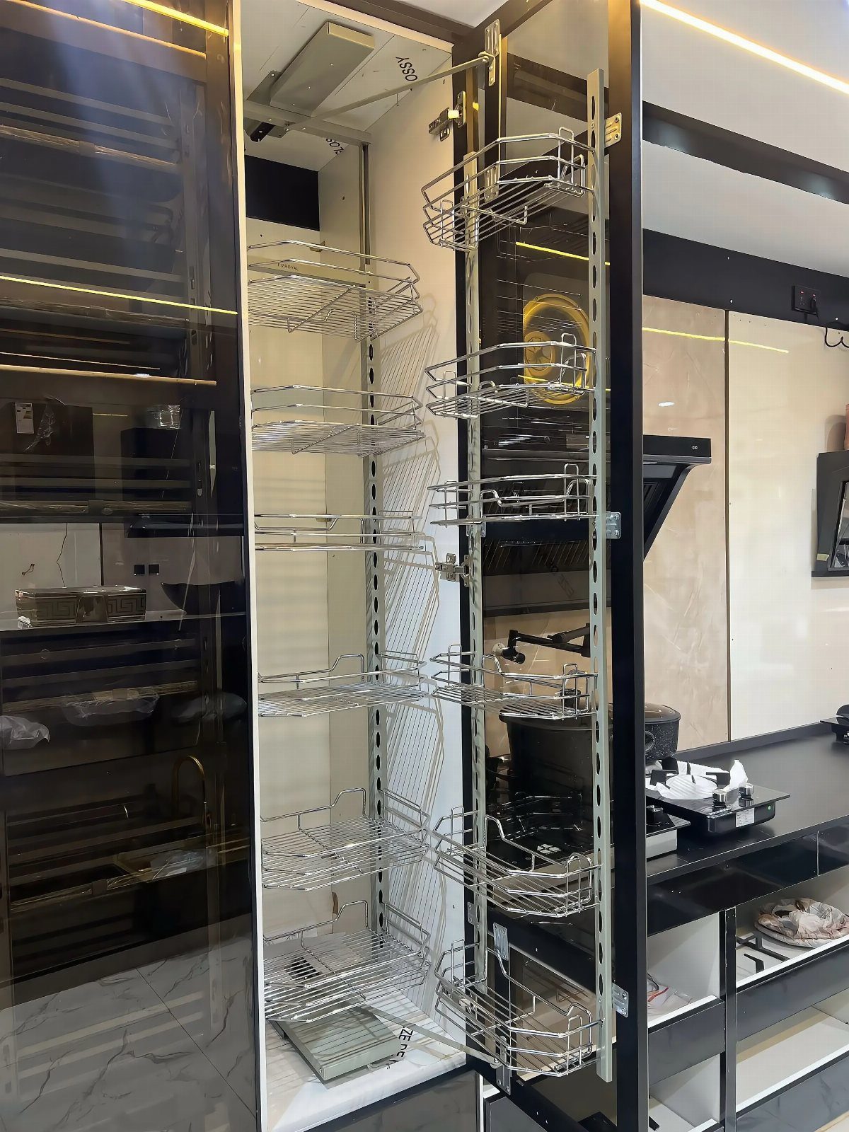 Chrome wire pull-out shelves inside a tall, narrow kitchen pantry cabinet.